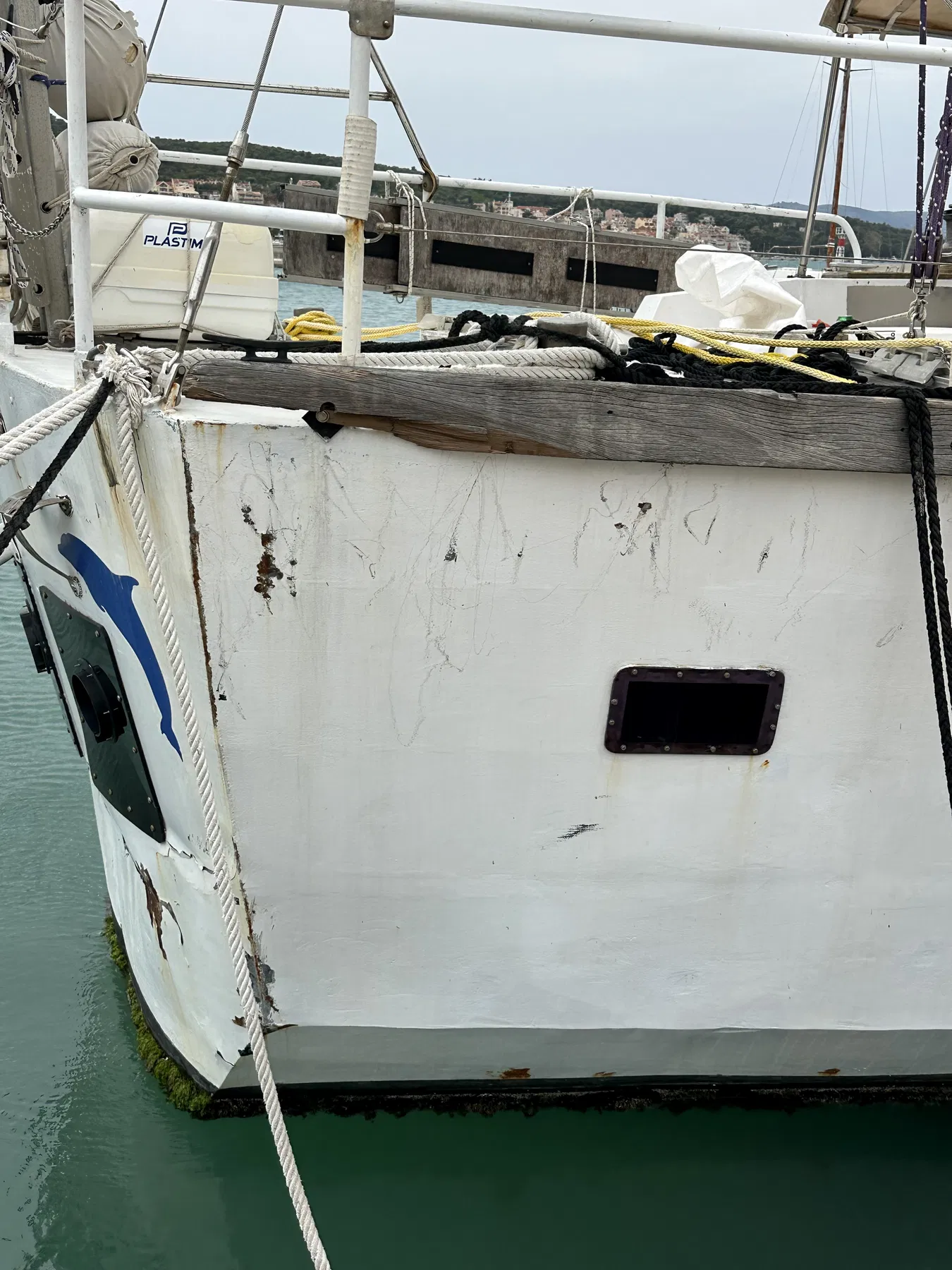 NAUSICAA, le bateau identifié dans le déroulé documenté comme ayant heurté SANKARA — section latérale de coque avec hublot, aussières et défense en pneu.